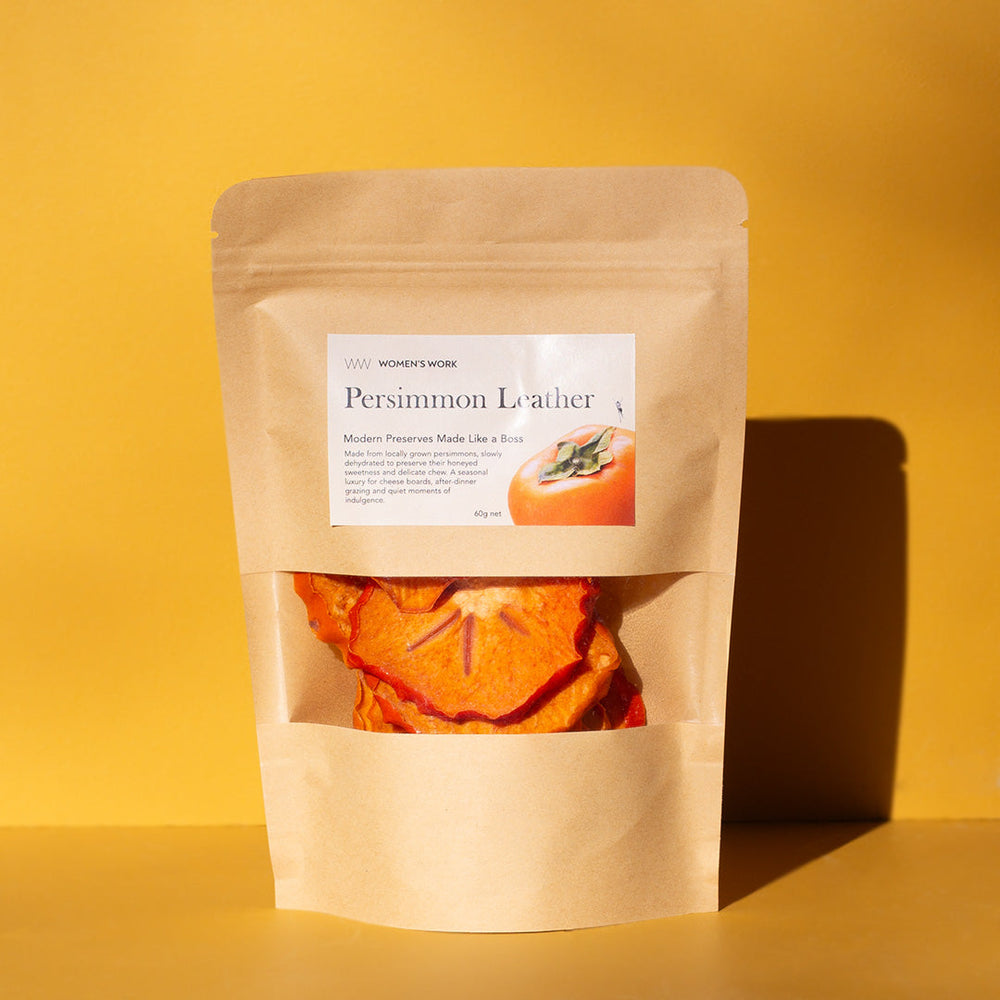 Women's Work Persimmon Leather 60g kraft pouch of 100% dried persimmon on a yellow background