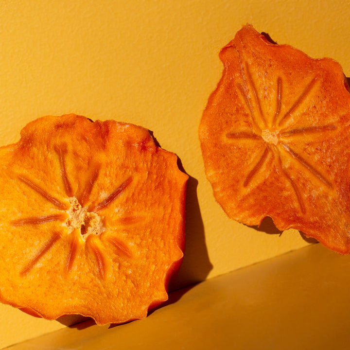 Close up of two dehydrated persimmon slices from Women's Work Persimmon Leather