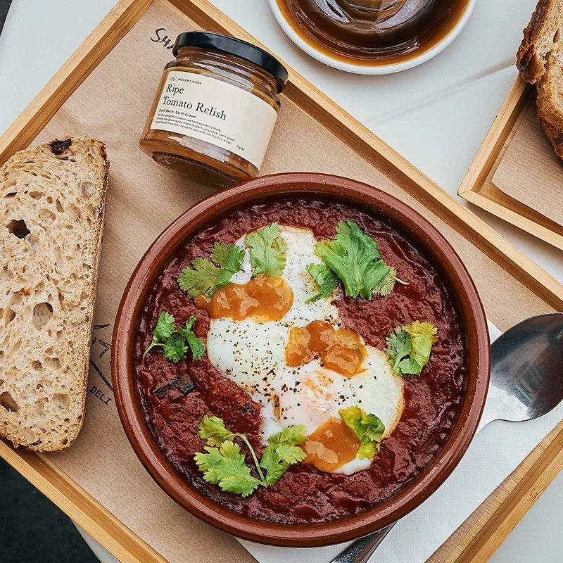 Shakshuka with eggs and Women's Work Ripe Tomato Relish, served with sourdough